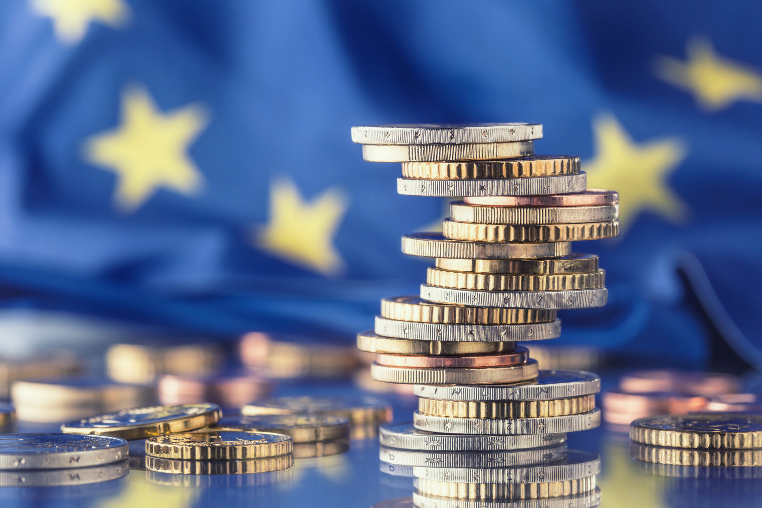 Euro money.Euro Flag.Euro currency.Coins stacked on each other in different positions. European union flag Euro money.Euro Flag.Euro currency.Coins stacked on each other in different positions. European union flag.